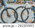 Close-up of city bike wheels on crowdy street 26283993