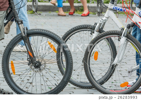 Close-up of city bike wheels on crowdy street 26283993