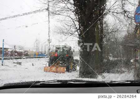 A tractor on a road during a snow storm A tractor on a road during a snow storm 26284264