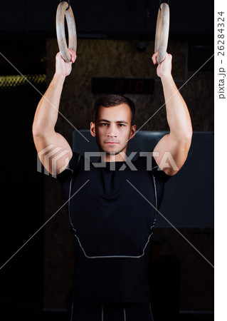 man using gymnastic rings man using gymnastic rings 26284324