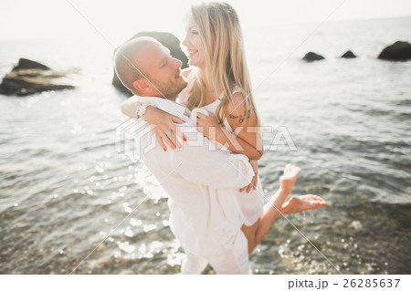 Fashion model couple with tattoo posing outside 26285637