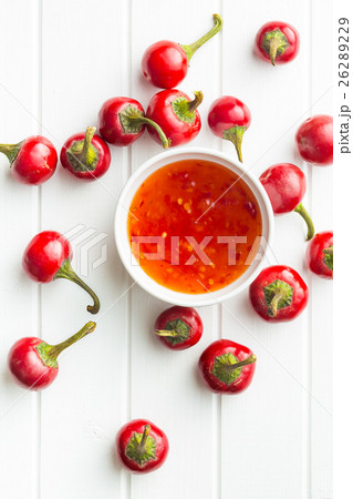 Red chili peppers and chili sauce. Red chili peppers and chili sauce. 26289229