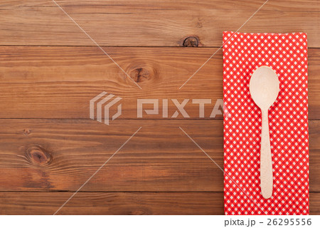 Spoon and napkin on wooden background. 26295556