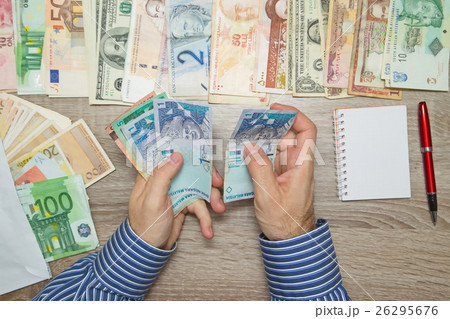Banker counting Malaysian Money at his office tabl Banker counting Malaysian Money at his office tabl 26295676