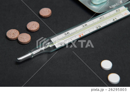 Bunch of pills with thermometer on the table Bunch of pills with thermometer on the table 26295803