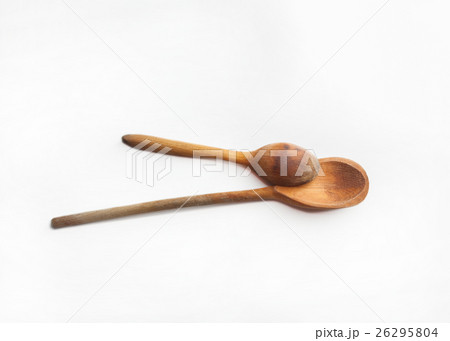 Two wooden spoons isolated on white background Two wooden spoons isolated on white background 26295804