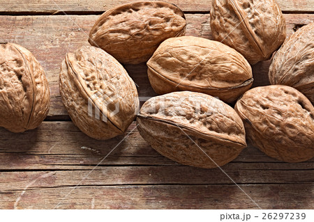 Walnuts on a rough wooden background 26297239