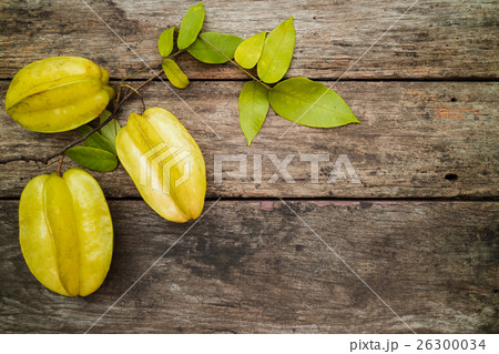 green fruit with leaves on the wooden table 26300034