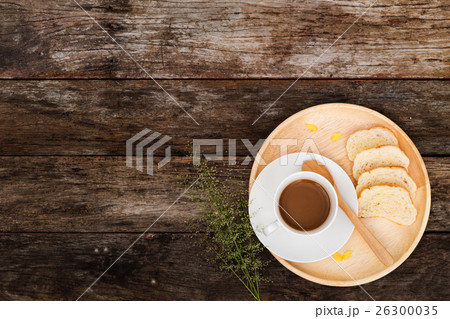 coffee mug with slice bread on wooden plate 26300035