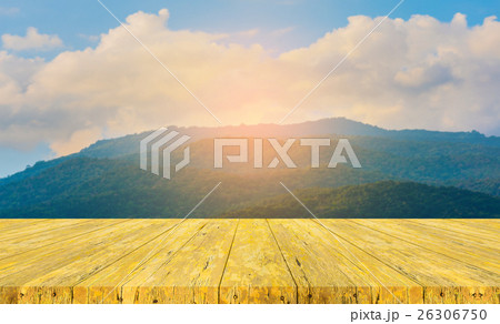 wood table and blur image of green mountain. wood table and blur image of green mountain. 26306750