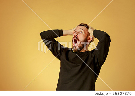 Portrait of young man with shocked facial 26307876