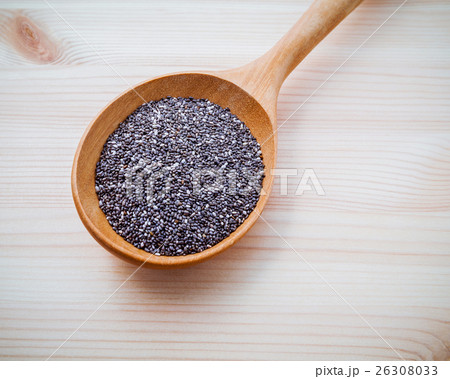 Nutritious chia seeds in wooden spoon . Nutritious chia seeds in wooden spoon . 26308033
