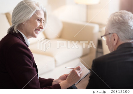 Happy businesswoman discussing the topic with her Happy businesswoman discussing the topic with her 26312100
