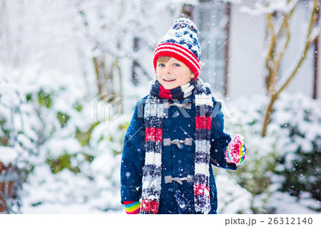 Happy kid boy having fun with snow in winter Happy kid boy having fun with snow in winter 26312140