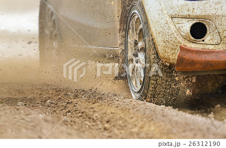 Rally racing car increase speed in muddy road 26312190