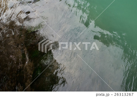 The glossy surface of the lake with turquoise wate 26313267