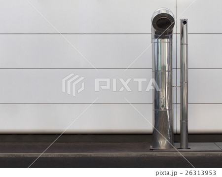 Two chrome industrial vents on sidewalk Two chrome industrial vents on sidewalk 26313953