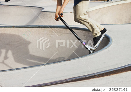 Push scooter boy in skate-park Push scooter boy in skate-park 26327141