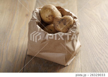 fresh potatoes in kraft paper bag on oak table fresh potatoes in kraft paper bag on oak table 26329033