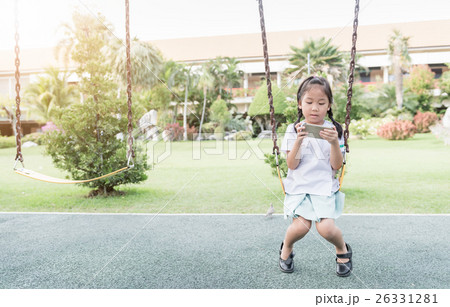 cute girl student play smart phone on swing cute girl student play smart phone on swing 26331281