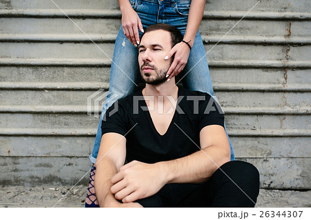 man sits on a background gray wall man sits on a background gray wall 26344307
