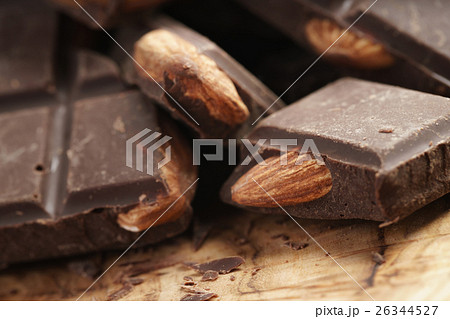 homemade dark chocolate with almond nuts on wooden board homemade dark chocolate with almond nuts on wooden board 26344527