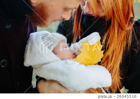 young family and newborn son in autumn park young family and newborn son in autumn park 26345510