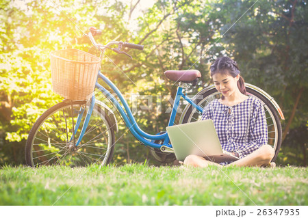 woman sit on lawn with using work laptop woman sit on lawn with using work laptop 26347935
