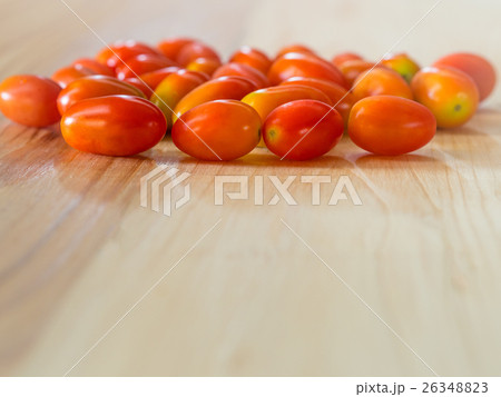 Cherry Tomatoes on pine wooden table. Cherry Tomatoes on pine wooden table. 26348823