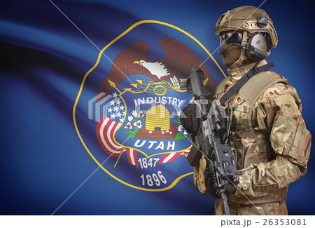 Soldier in helmet holding machine gun with USA state flag on background series - Utah Soldier in helmet holding machine gun with USA state flag on background series - Utah 26353081