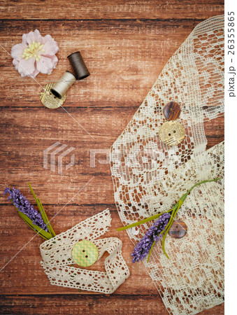Lace and thread on wooden background 26355865