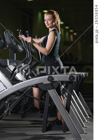 Young woman at the gym exercising. Run on machine. 26356954