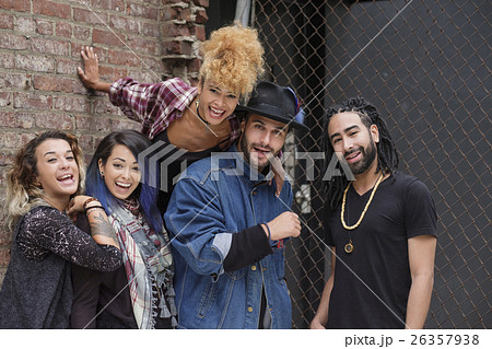 Portrait of happy friends against brick wall 26357938