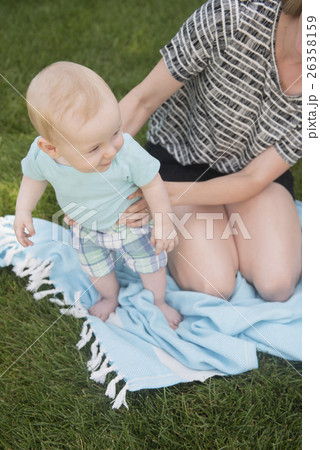 Mother with son (6-11 months) playing on grass 26358159