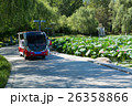 Tour bus following along lotus pond. 26358866