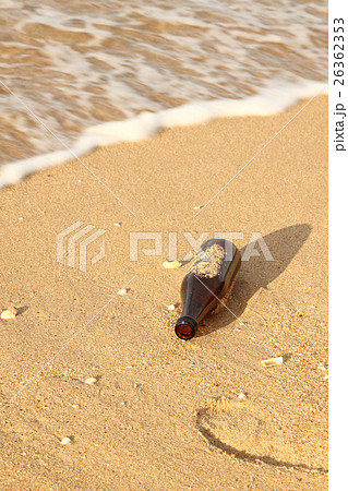 Stained sand help opened bottle on sea shore. 26362353