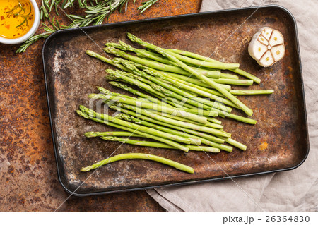 raw asparagus with salt and olive oil on pan, 26364830