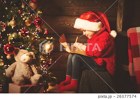 happy child girl writes letter to Santa Claus at the Christmas t 26377574