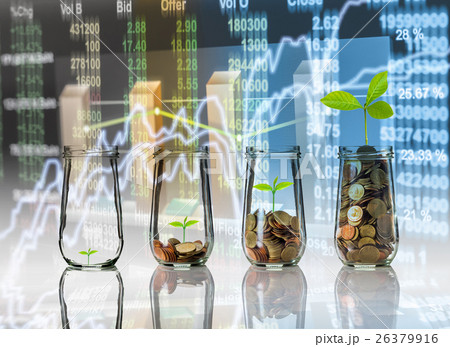 Gold coins and seed in clear bottle on Stock market exchange data on LED display background, Business investment growth and trading concept 26379916