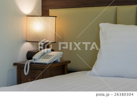 Closeup pillow on the bed with lamp in luxury hotel 26380304