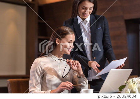 Delighted female colleagues working together in Delighted female colleagues working together in 26384034