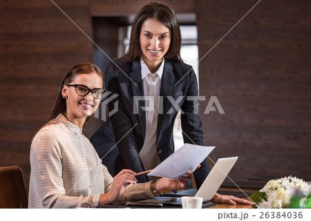 Beautiful colleagues posing in their office. Beautiful colleagues posing in their office. 26384036