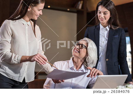 Female colleagues discussing their work with boss Female colleagues discussing their work with boss 26384076