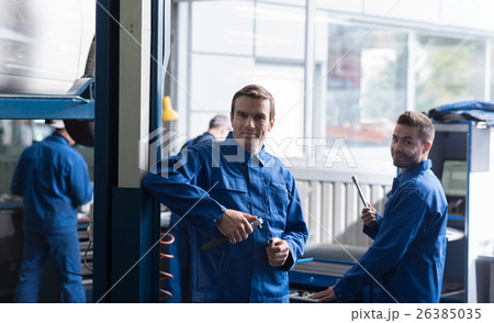 Cheerful auto mechanics holding tools 26385035