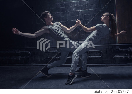 Involved dancers warming up in close interaction 26385727