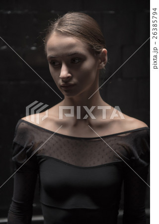 Concentrated dancer standing in the dark room Concentrated dancer standing in the dark room 26385794