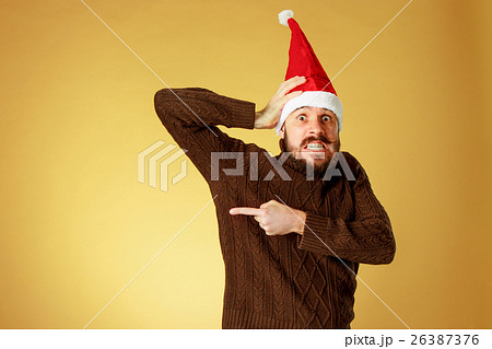 The serious christmas man wearing a santa hat The serious christmas man wearing a santa hat 26387376