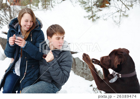 Couple drinking hot drink outdoors 26389474