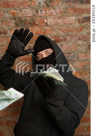 Robber in mask throws banknotes Robber in mask throws banknotes 26394516