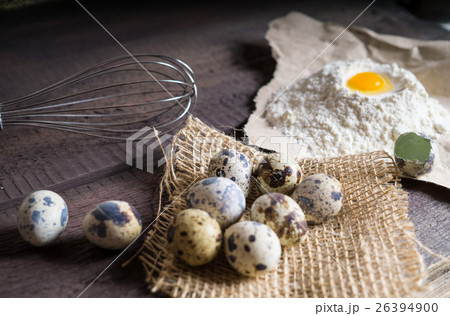 Quail eggs, flour, whisk on wooden background 26394900